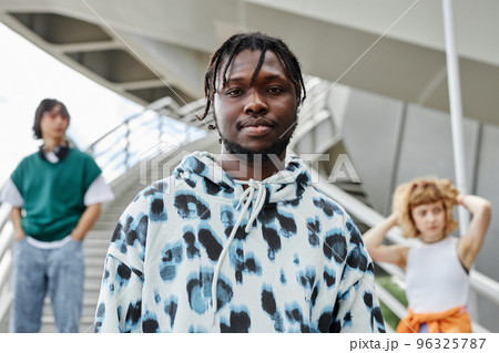 Diverse group of young people wearing street style clothes outdoors 96325787