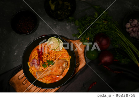 Khao Soi Kai or creamy and slightly spicy yellow curry with chicken drumstick Khao Soi Kai or creamy and slightly spicy yellow curry with chicken drumstick 96328759