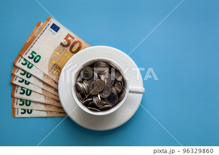 Euro banknotes and a cup 96329860