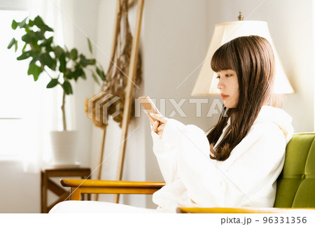 スマホを見て疲れを感じる若い女性 スマホを見て疲れを感じる若い女性 96331356