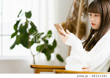 スマホを見て疲れを感じる若い女性 96331381