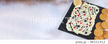 Sweet Butter board topped with chocolate, pomegranate seeds, blueberries. 96331412