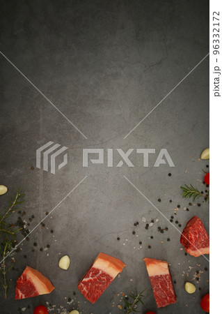 Raw fresh meat Picanha chopped in cubes with black pepper, sea salt and rosemary and spices on stone background 96332172