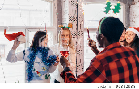 Friends with sparklers in hands. Group of friends celebrating Christmas eve together. 96332938