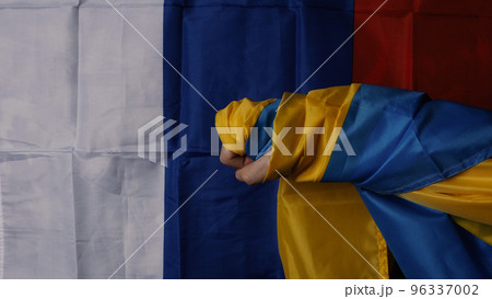 Russian flag and Ukrainian flag on a black background. Russian flag and Ukraine flag in hands showing symbol of struggle war political struggle political expressions Civil wars and territory conflict. 96337002