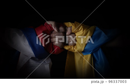 Russian flag and Ukrainian flag on a black background. Russian flag and Ukraine flag in hands showing symbol of struggle war political struggle political expressions Civil wars and territory conflict. 96337003