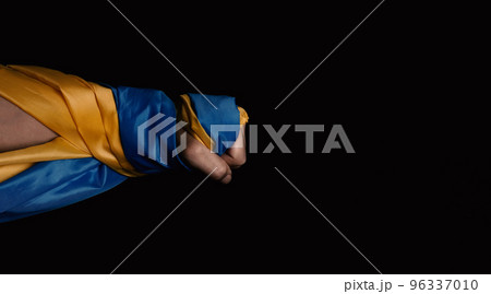 Russian flag and Ukrainian flag on a black background. Russian flag and Ukraine flag in hands showing symbol of struggle war political struggle political expressions Civil wars and territory conflict. Russian flag and Ukrainian flag on a black background. Russian flag and Ukraine flag in hands showing symbol of struggle war political struggle political expressions Civil wars and territory conflict. 96337010