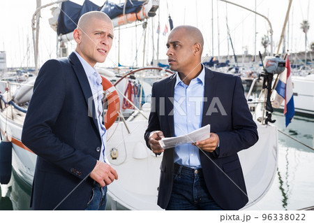two male businessmen agree on a deal at the seaport two male businessmen agree on a deal at the seaport 96338022