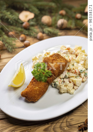 Christmas fried carp with potato salad Christmas fried carp with potato salad 96338171