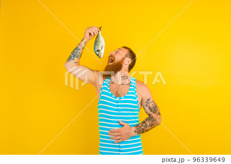 man with beard and swimsuit caught a fish man with beard and swimsuit caught a fish 96339649