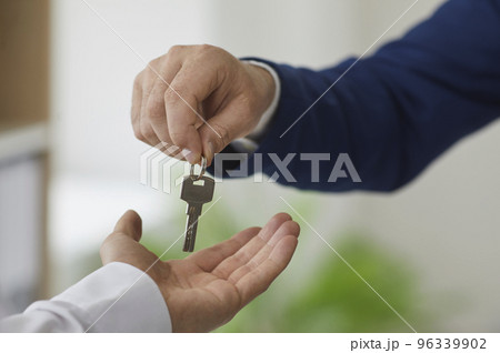Man takes keys from real estate agent after signing lease or purchase agreement. Man takes keys from real estate agent after signing lease or purchase agreement. 96339902