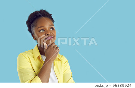 Young woman dreaming or thinking about something isolated on blue copy space background 96339924