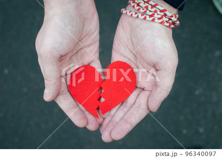 Divorce concept - Broken heart in the male hands. 96340097