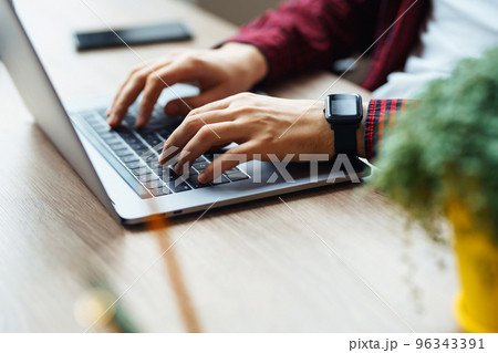 Close up picture of male hands working on her laptop. Social networking technology concept. Close up picture of male hands working on her laptop. Social networking technology concept. 96343391