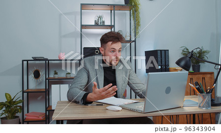 Angry businessmanin ceo making laptop call conversation at home office, quarrel conflict negotiation Angry businessmanin ceo making laptop call conversation at home office, quarrel conflict negotiation 96343904