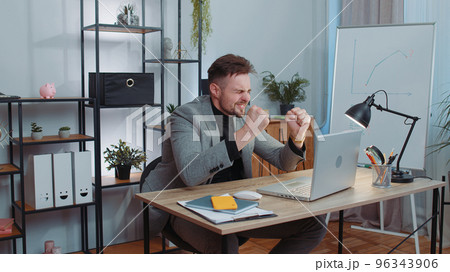 Business man working on laptop loses becoming surprised sudden lottery results bad news fortune loss 96343906