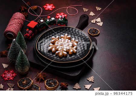 Beautiful different Christmas decorations and gingerbread on a brown concrete table 96344175