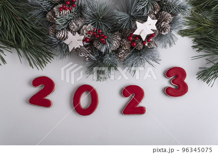 2023 inscription and Christmas wreath, top view. White background. Happy New Year 2023 96345075