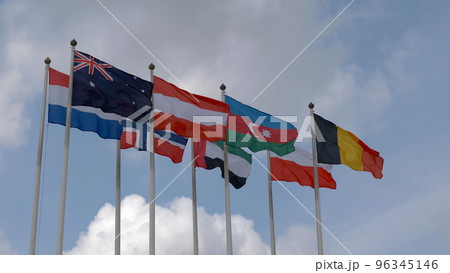 Various national flags with the EU flag under a blue sky. 96345146