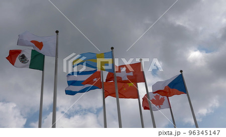 Various national flags with the EU flag under a blue sky. 96345147