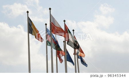Various national flags with the EU flag under a blue sky. 96345344