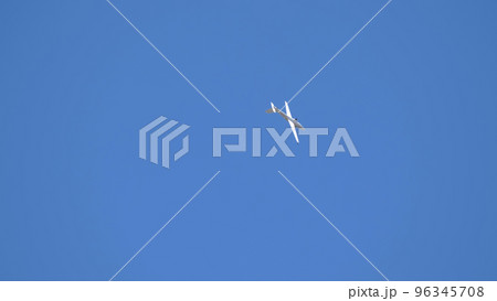 Red small sport plane flying in the sky pulls on a rope the glider plane Red small sport plane flying in the sky pulls on a rope the glider plane 96345708
