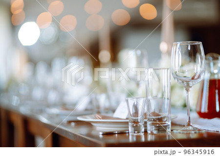 Beautiful table setting for a party, wedding reception or other festive event. Banquet setting, glasses, plates. Beautiful table setting for a party, wedding reception or other festive event. Banquet setting, glasses, plates. 96345916