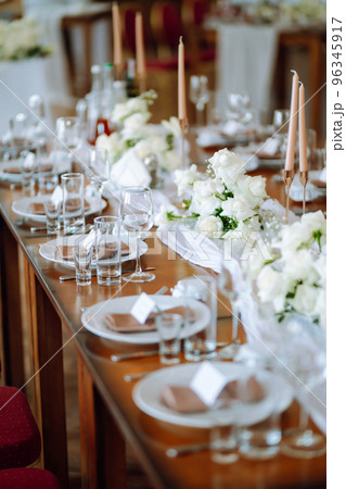 Beautiful table setting for a party, wedding reception or other festive event. Banquet setting, glasses, plates. Beautiful table setting for a party, wedding reception or other festive event. Banquet setting, glasses, plates. 96345917
