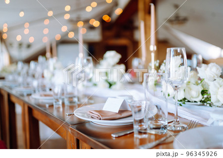 Beautiful table setting for a party, wedding reception or other festive event. Banquet setting, glasses, plates. Beautiful table setting for a party, wedding reception or other festive event. Banquet setting, glasses, plates. 96345926