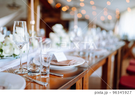 Beautiful table setting for a party, wedding reception or other festive event. Banquet setting, glasses, plates. Beautiful table setting for a party, wedding reception or other festive event. Banquet setting, glasses, plates. 96345927