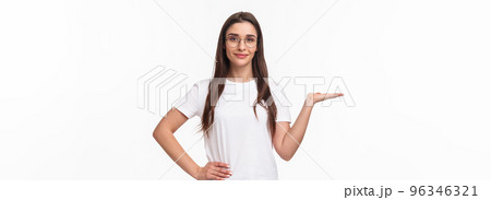 Waist-up portrait of pleasant good-looking caucasian female in glasses, attractive girl holding someone on hand, raising arm as have product on it, smiling camera, advertise, white background 96346321