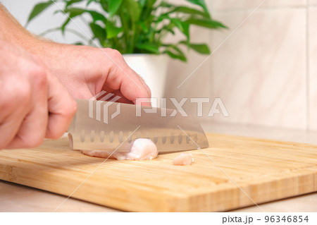 Defrosted raw chicken fillet on cutting board Defrosted raw chicken fillet on cutting board 96346854