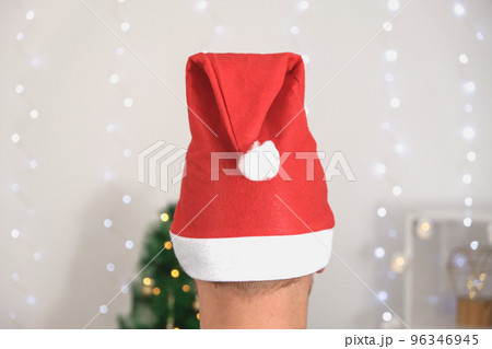A man in a Christmas hat and a festive sweater on 96346945