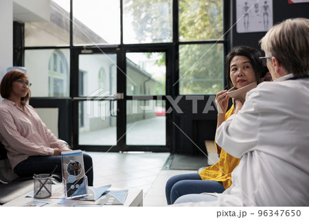 Medical specialist helping old patient with cervical collar removing neck brace after accident rehabilitation. Injured woman healing fracture and trauma and doing health checkup. Medicine concept Medical specialist helping old patient with cervical collar removing neck brace after accident rehabilitation. Injured woman healing fracture and trauma and doing health checkup. Medicine concept 96347650