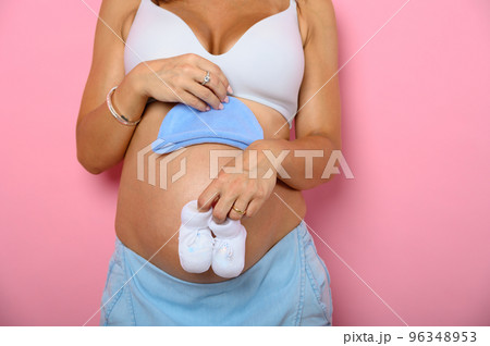 Pregnant mom prepares the clothes for the baby 96348953