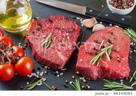 Fresh raw beef steak with spice on black background Fresh raw beef steak with spice on black background 96349085