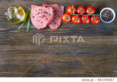 Raw steak with spices and ingredients for cooking. Flat lay. Top view. Raw steak with spices and ingredients for cooking. Flat lay. Top view. 96349087