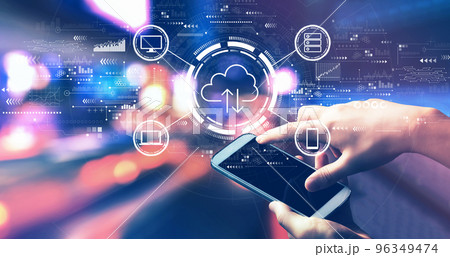 Cloud computing with person using a smartphone at night Cloud computing with person using a smartphone at night 96349474