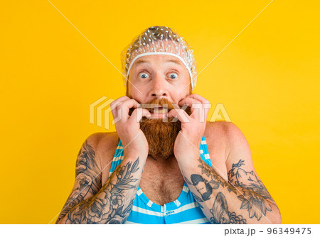 man with swimsuit and hair cap for women is ready for the summer man with swimsuit and hair cap for women is ready for the summer 96349475