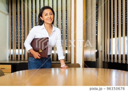 Portrait of business woman standing in office Portrait of business woman standing in office 96350676