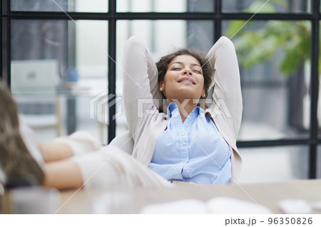 Tired businesswoman sleeping with closed eyes at workplace Tired businesswoman sleeping with closed eyes at workplace 96350826