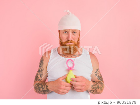 Delusion man with beard and tattoos acts like a small newborn 96351879