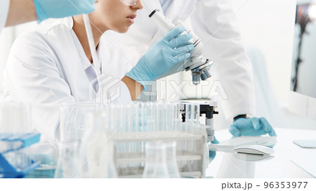 scientists are conducting research in a medical laboratory . scientists are conducting research in a medical laboratory . 96353977