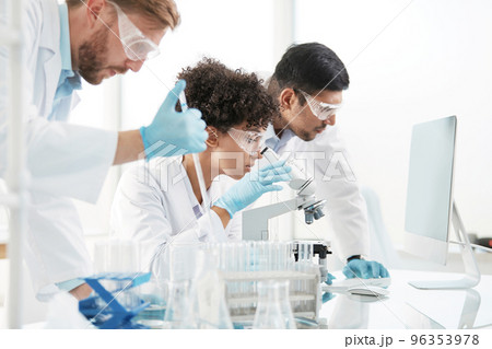 scientists are conducting research in a medical laboratory . scientists are conducting research in a medical laboratory . 96353978