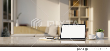 Workspace marble tabletop with tablet mockup and stuff over blurred minimal living room 96354287