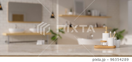 Bathroom accessories and copy space on white marble tabletop over blurred modern bathroom 96354289