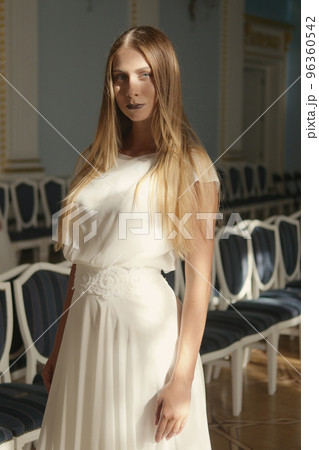 Beautiful young woman in ivory silk dress 96360542