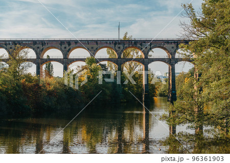 Railway Bridge with river in Bietigheim-Bissingen, Germany. Autumn. Railway viaduct over the Enz River, built in 1853 by Karl von Etzel on a sunny summer day. Bietigheim-Bissingen, Germany. Old 96361903