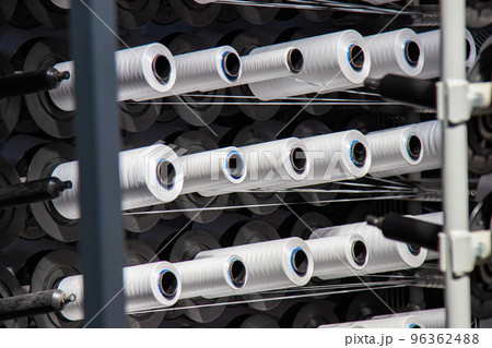 Coils of white flat polypropylene yarn for the production of industrial bags. circular loom woven bag machine. Production of polypropylene sleeves. 96362488