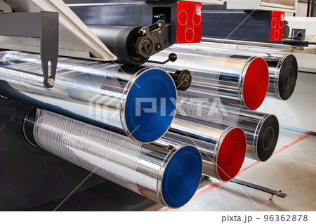 Production of white polypropylene flat yarn for the production of industrial bags. The shafts are spinning. Cellophane moves between the shafts. Polypropylene Cloth is cut into thin flat threads. 96362878